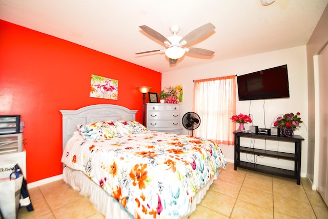 bedroom with a ceiling fan, baseboards, and light tile patterned floors