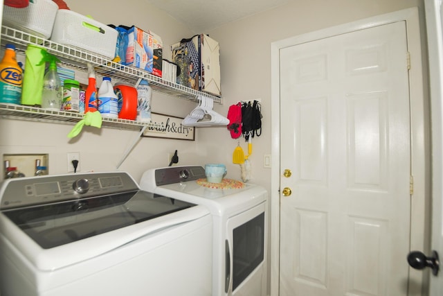 washroom with laundry area and washing machine and dryer