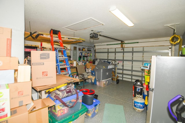 garage with a garage door opener and freestanding refrigerator