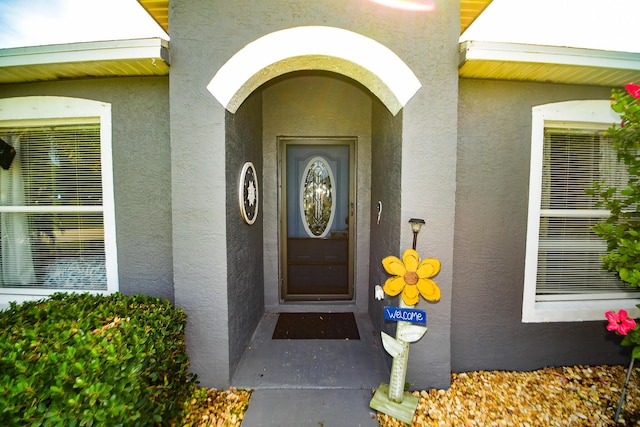 property entrance with stucco siding