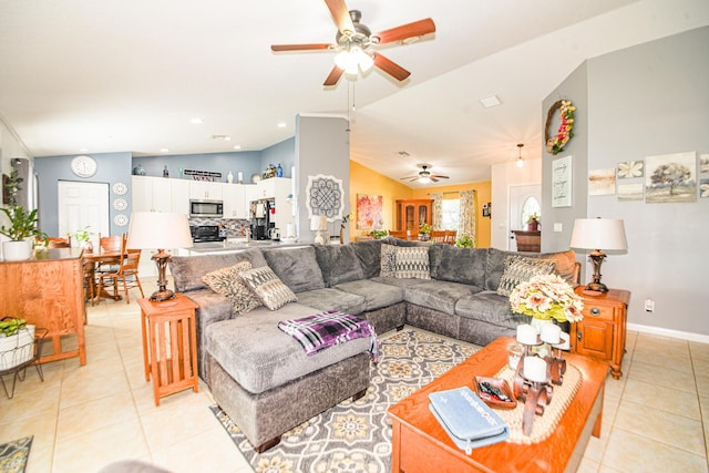 living room with lofted ceiling, light tile patterned floors, baseboards, and a ceiling fan