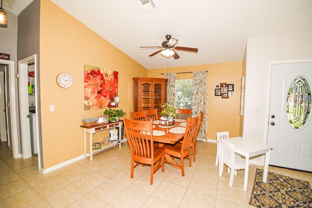 dining room with baseboards, visible vents, a ceiling fan, vaulted ceiling, and light tile patterned flooring