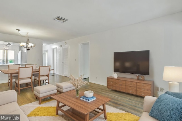 living room featuring a chandelier and hardwood / wood-style floors