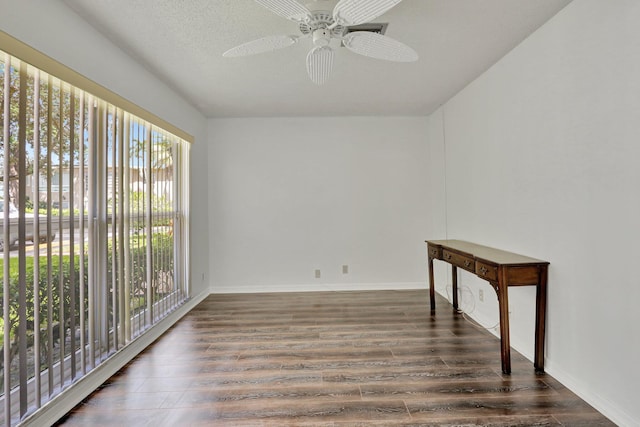 spare room with ceiling fan, dark hardwood / wood-style floors, and a textured ceiling