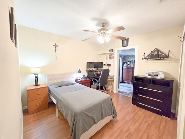 bedroom with light hardwood / wood-style floors and ceiling fan