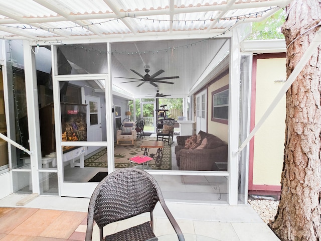 sunroom / solarium featuring ceiling fan