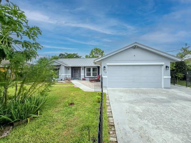 single story home featuring a garage and a front lawn