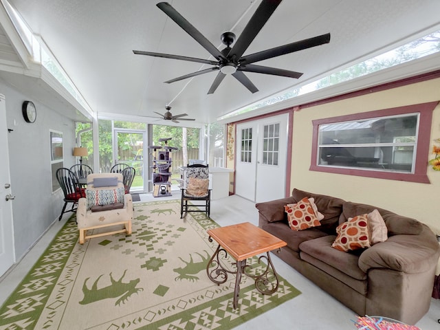 living room with french doors, ceiling fan, and vaulted ceiling