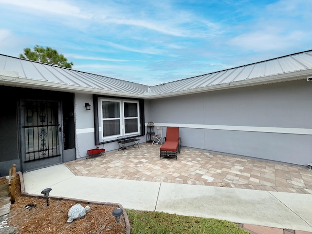 doorway to property featuring a patio