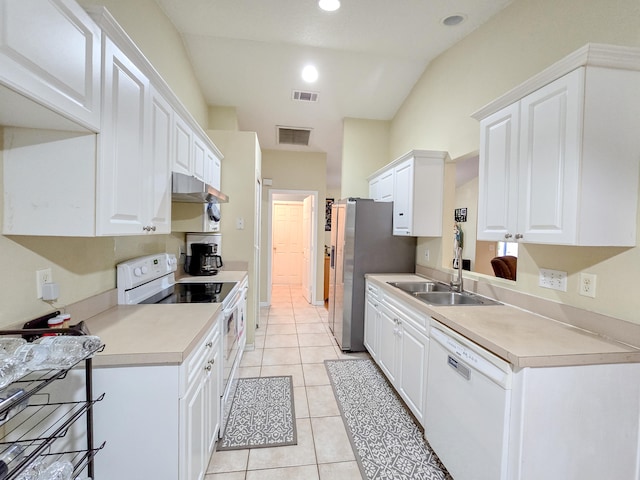 kitchen with light tile patterned flooring, white cabinets, white appliances, sink, and lofted ceiling