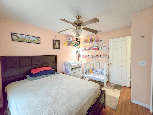 bedroom featuring light hardwood / wood-style floors and ceiling fan