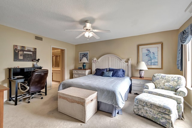 carpeted bedroom with ceiling fan, a textured ceiling, and connected bathroom