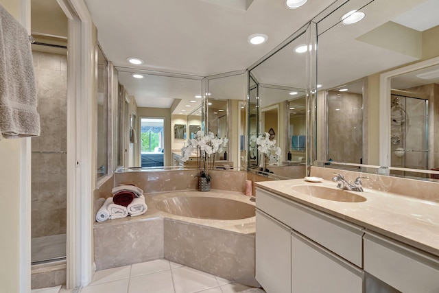 bathroom with tile patterned floors, vanity, and separate shower and tub