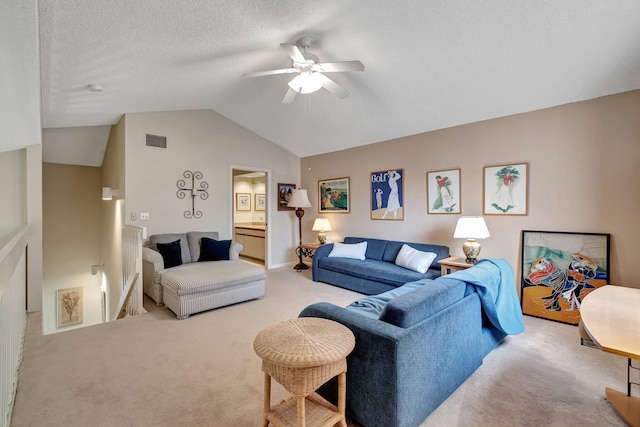 carpeted living room featuring ceiling fan, a textured ceiling, and vaulted ceiling