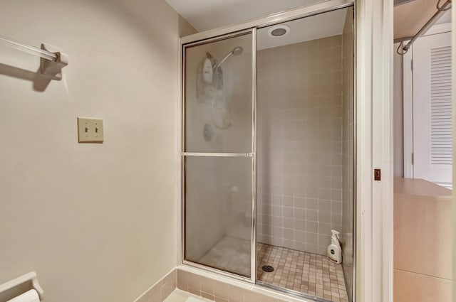 bathroom with a shower with shower door