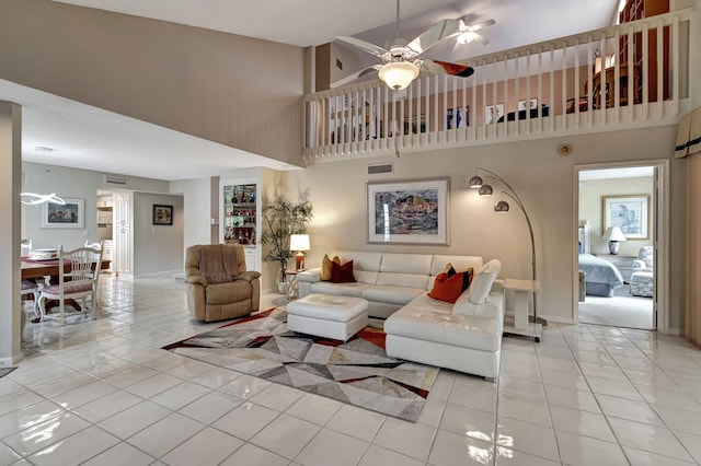 tiled living room featuring a towering ceiling and ceiling fan