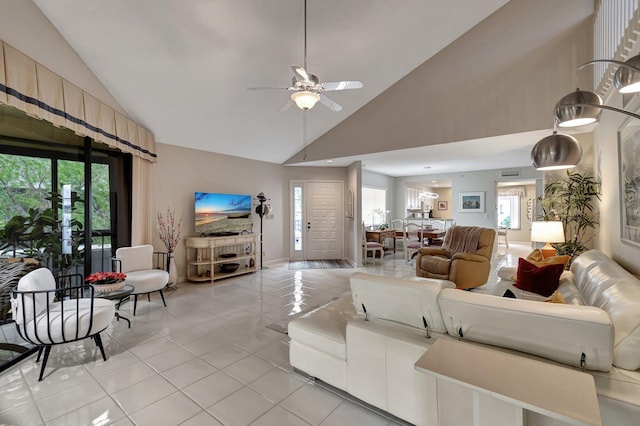 tiled living room featuring ceiling fan, high vaulted ceiling, and plenty of natural light