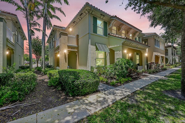 mediterranean / spanish-style home featuring a balcony