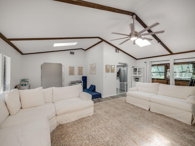 living room featuring crown molding, wood-type flooring, lofted ceiling with skylight, and ceiling fan