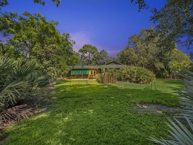 view of yard at dusk