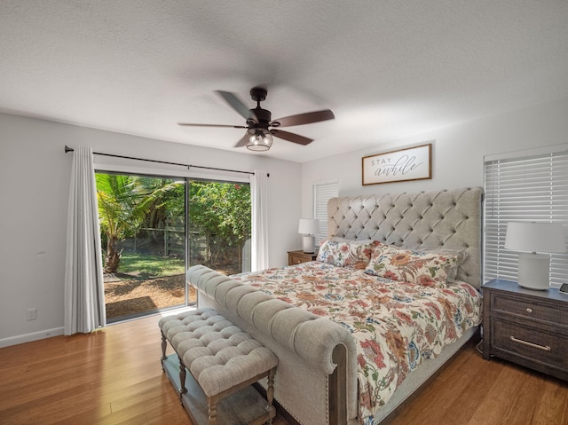 bedroom with ceiling fan, light wood-type flooring, a textured ceiling, and access to outside