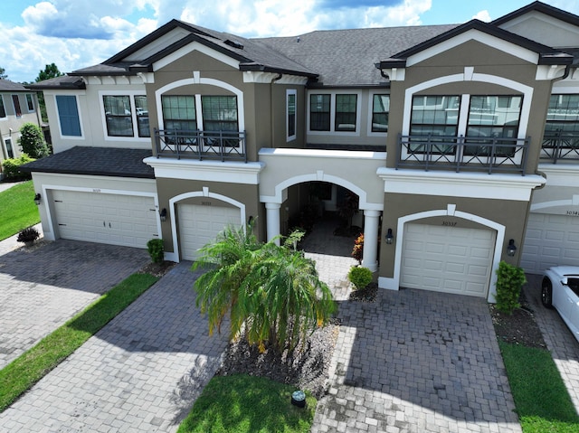 view of front of property with a balcony and a garage