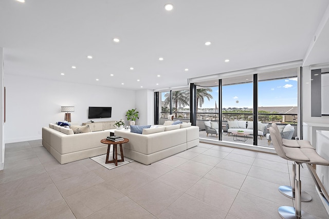 living room featuring expansive windows and light tile patterned floors