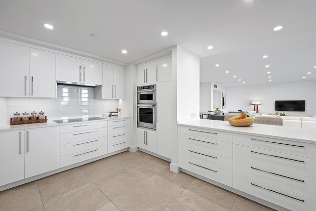 kitchen featuring black electric stovetop, light tile patterned floors, stainless steel double oven, white cabinets, and tasteful backsplash