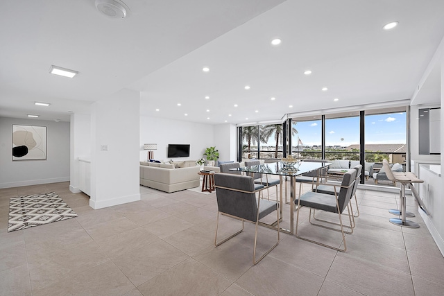 dining room featuring expansive windows and light tile patterned floors