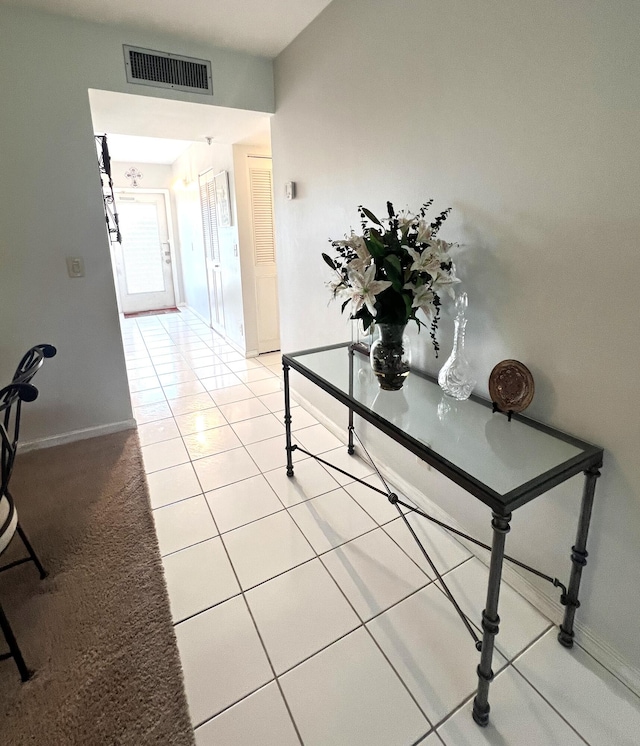 hallway featuring light tile patterned flooring