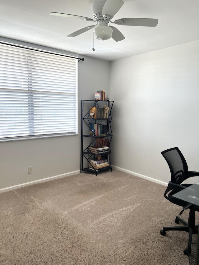 office space featuring ceiling fan, carpet flooring, and plenty of natural light