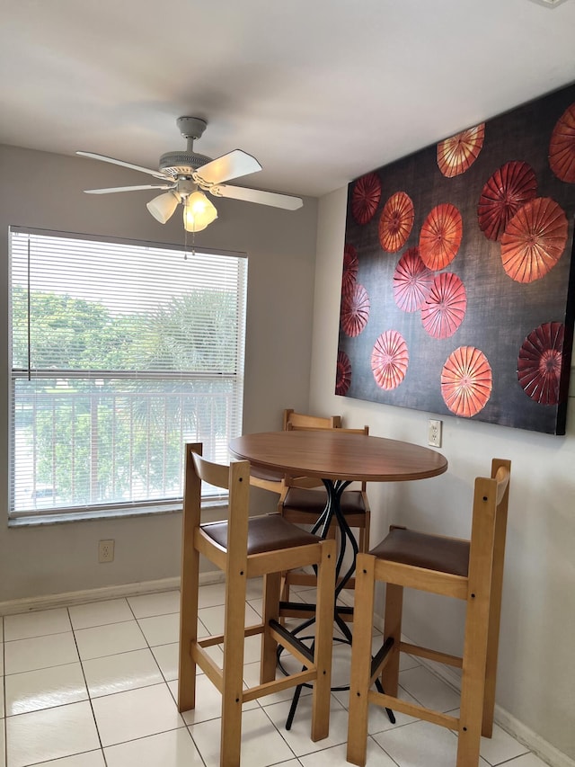 tiled dining room with ceiling fan