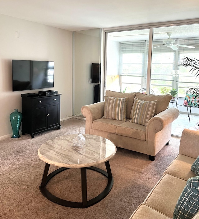 carpeted living room with ceiling fan