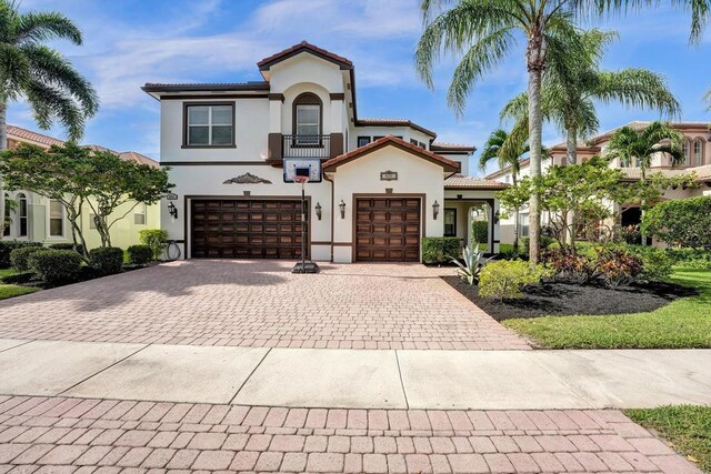 mediterranean / spanish-style house with a garage