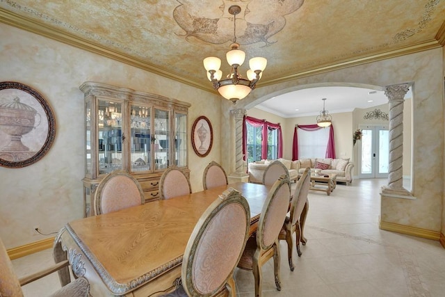 tiled dining space with ornate columns, crown molding, and a chandelier