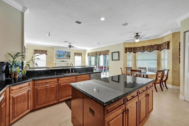 kitchen with ceiling fan, sink, plenty of natural light, and light tile patterned floors