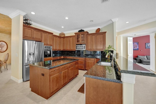 kitchen featuring crown molding, appliances with stainless steel finishes, backsplash, sink, and kitchen peninsula