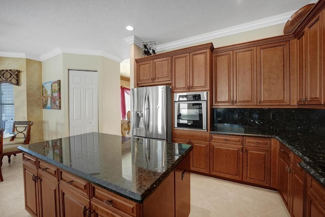 kitchen featuring light tile patterned floors, stainless steel appliances, a center island, and ornamental molding