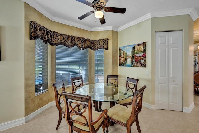 tiled dining space featuring ceiling fan and ornamental molding