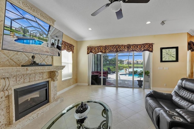 tiled living room with ceiling fan and crown molding