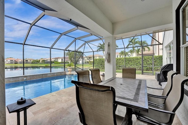 view of patio / terrace with a water view and a lanai