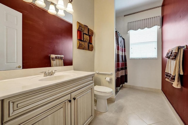 bathroom featuring vanity, toilet, and tile patterned flooring