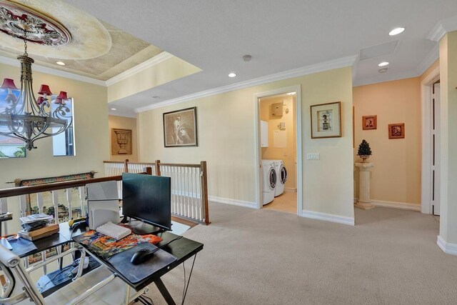 carpeted office space with a tray ceiling, washer and clothes dryer, and ornamental molding