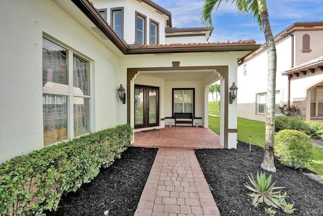 view of exterior entry featuring a patio area