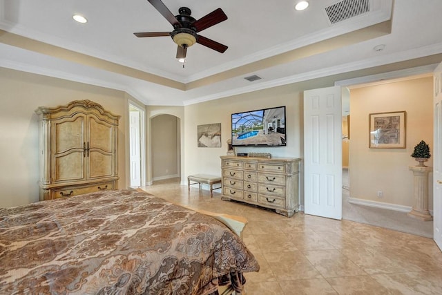 bedroom with ceiling fan, crown molding, a raised ceiling, and light tile patterned floors