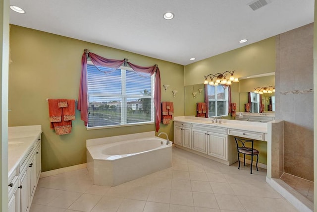 bathroom with vanity, tile patterned flooring, and a tub to relax in