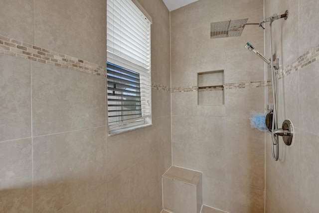 bathroom with a tile shower