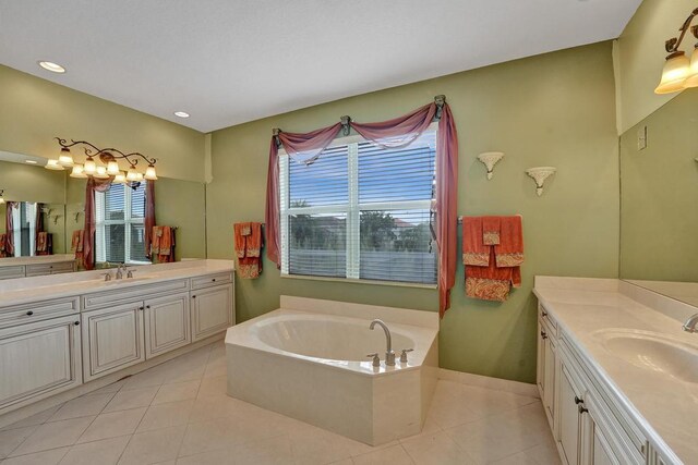 bathroom with tile patterned flooring, vanity, and a washtub