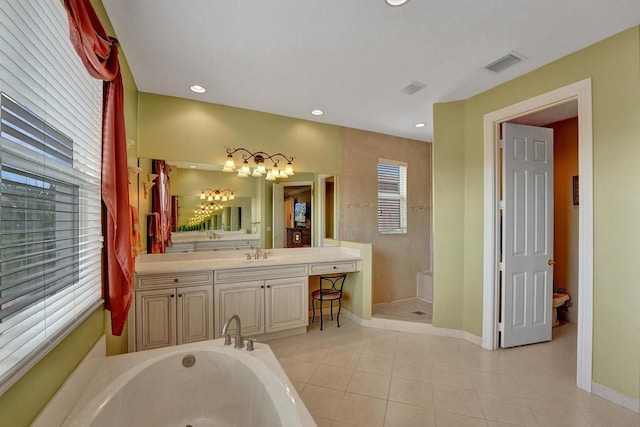 bathroom featuring vanity, plus walk in shower, tile patterned flooring, and a healthy amount of sunlight