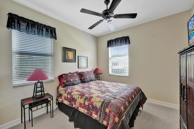 bedroom featuring ceiling fan and light carpet